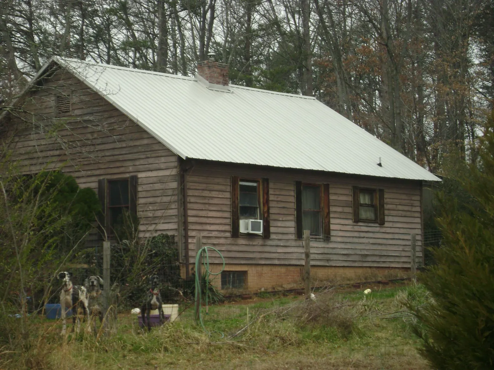 White metal roof on an old wood sided farmhouse, from a Metal Roof Installation job in Moss